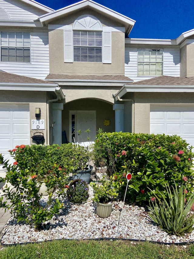 9189 Boca Gardens Cir Unit D, Boca Raton, FL 33496 - entrance to property with an attached garage, stucco siding, and a shingled roof