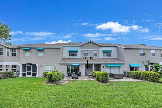 9189 Boca Gardens Cir Unit D, Boca Raton, FL 33496 - rear view of property with stucco siding and a lawn