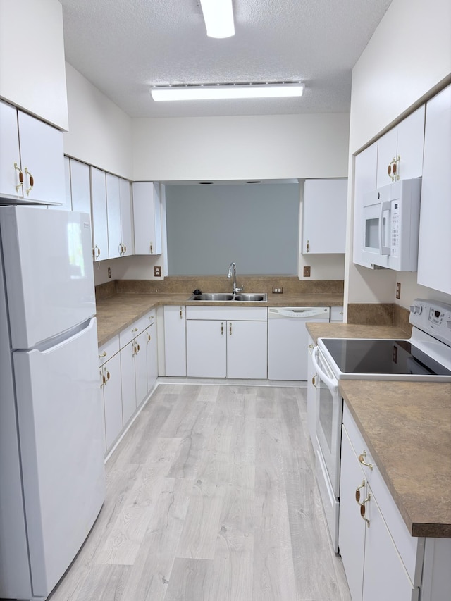9189 Boca Gardens Cir Unit D, Boca Raton, FL 33496 - kitchen featuring white appliances, white cabinets, a textured ceiling, and light wood finished floors