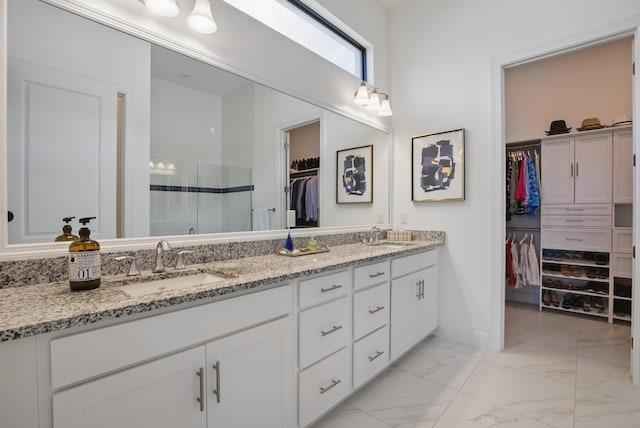 bathroom featuring vanity and an enclosed shower