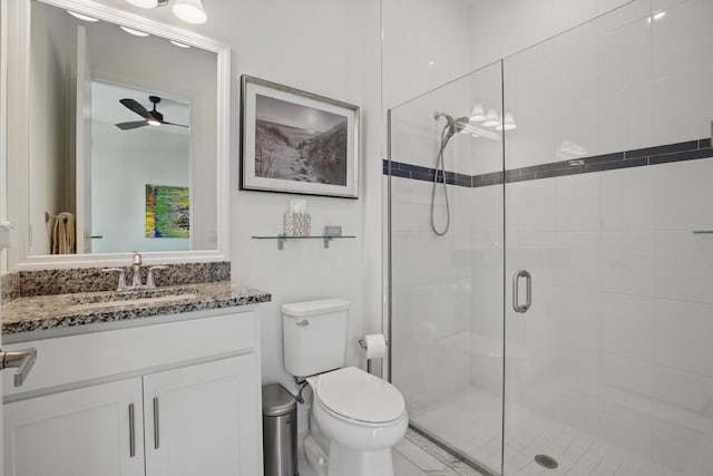 bathroom featuring vanity, an enclosed shower, and toilet