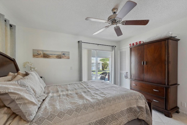 bedroom with light tile patterned floors, a textured ceiling, access to outside, and ceiling fan