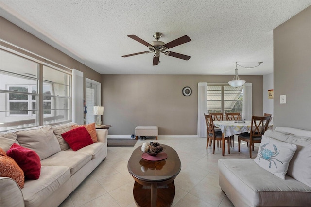 living room with a textured ceiling and ceiling fan