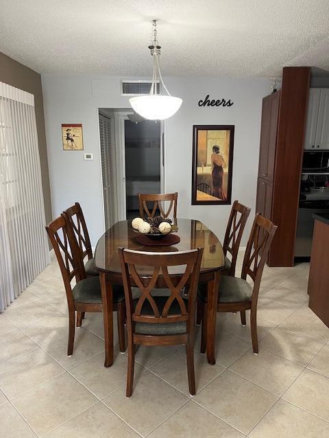 kitchen featuring light tile patterned flooring, washer / dryer, sink, stainless steel appliances, and white cabinets