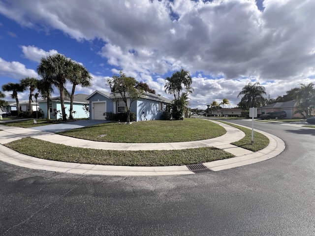 view of front of home featuring a garage and a front lawn