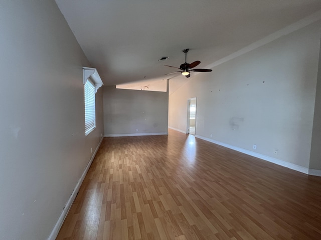 unfurnished room with ceiling fan, vaulted ceiling, and hardwood / wood-style floors