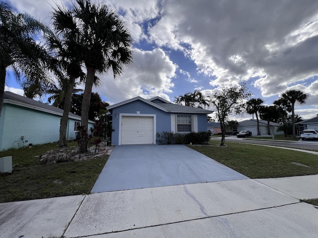 single story home featuring a garage and a front lawn