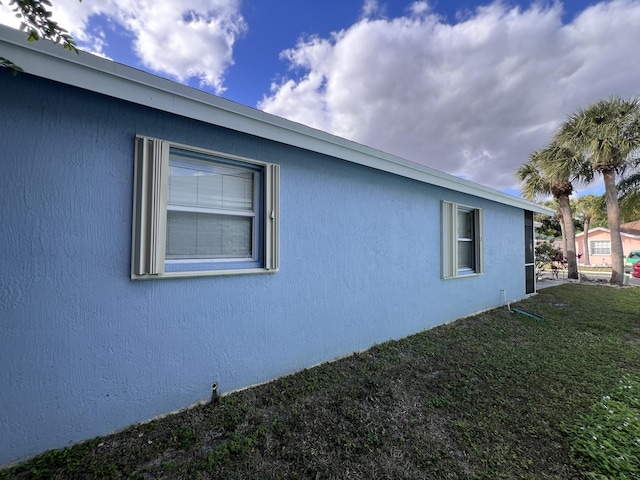 view of side of property with a lawn