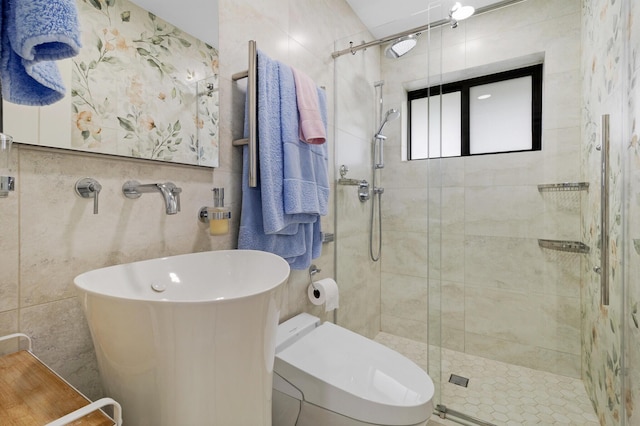 bathroom with toilet, a shower with door, and tile walls