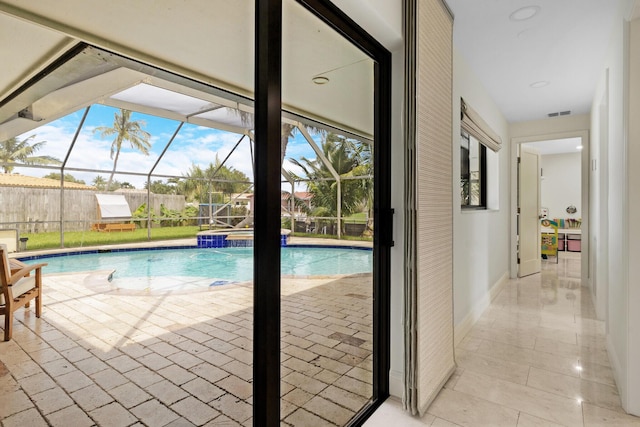 view of pool with a lanai, pool water feature, and a patio area