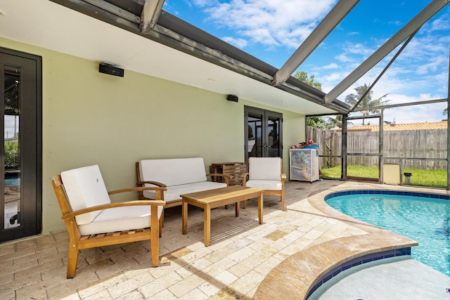 view of swimming pool with a patio and a lanai