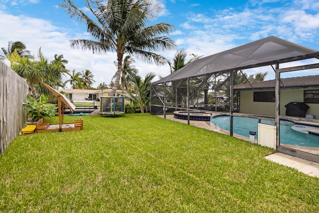 view of yard featuring a patio area, a pool with hot tub, and glass enclosure