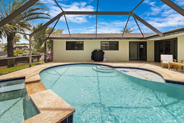 view of pool featuring a patio and glass enclosure