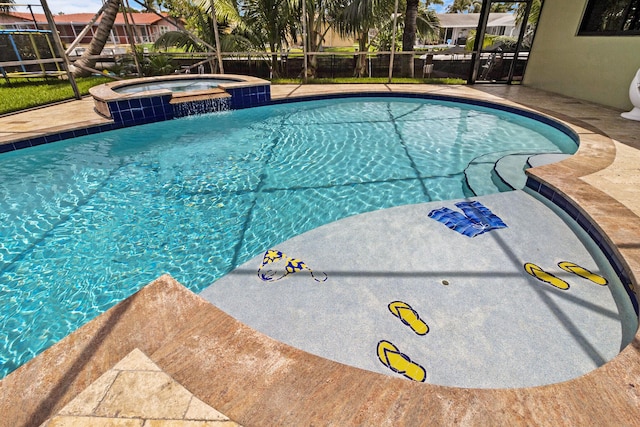 view of swimming pool featuring an in ground hot tub