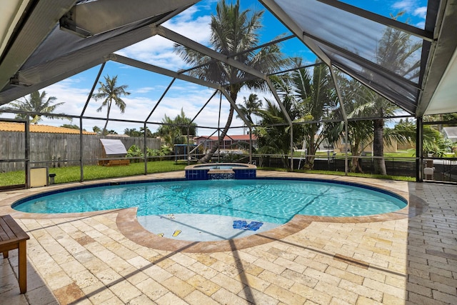 view of swimming pool featuring an in ground hot tub, glass enclosure, and a patio