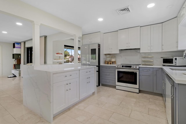 kitchen featuring appliances with stainless steel finishes, gray cabinetry, and white cabinets