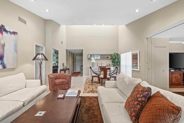 living room featuring a towering ceiling