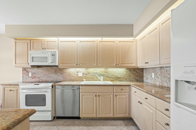 kitchen with sink, white appliances, light tile patterned floors, tasteful backsplash, and light brown cabinets