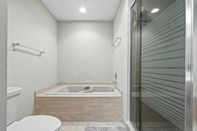 bathroom with shower with separate bathtub and toilet