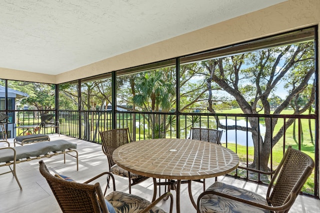 sunroom / solarium with a water view