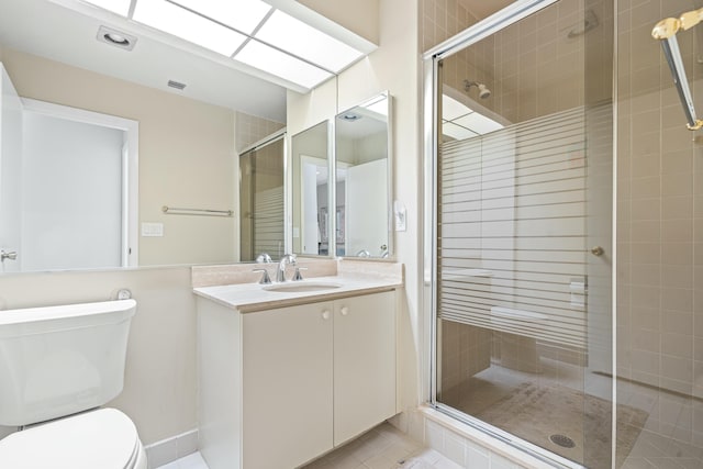 bathroom featuring an enclosed shower, vanity, tile patterned flooring, and toilet