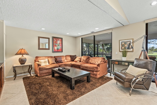 living room with a textured ceiling and light tile patterned flooring