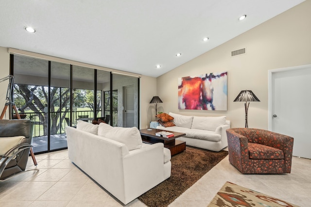 living room featuring light tile patterned floors, vaulted ceiling, and floor to ceiling windows