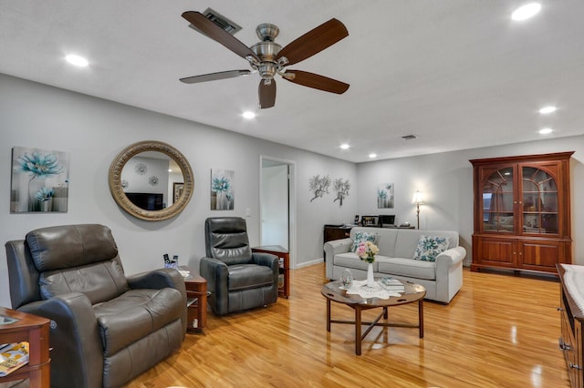 living room with ceiling fan and light hardwood / wood-style floors