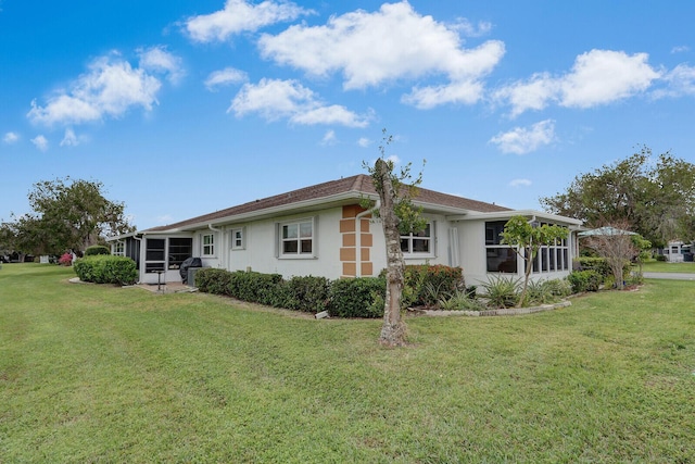 back of property featuring a lawn