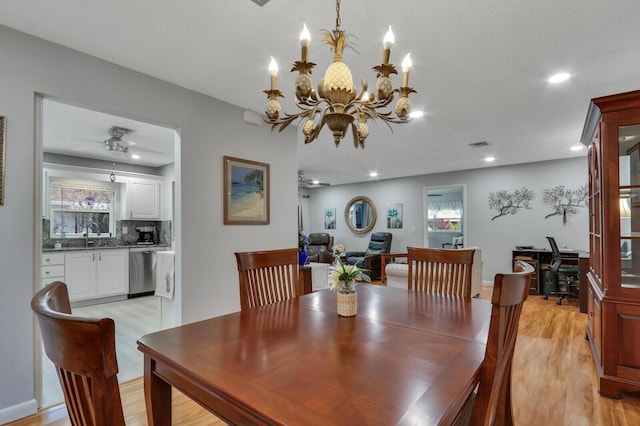 dining area with sink, ceiling fan, and light hardwood / wood-style flooring