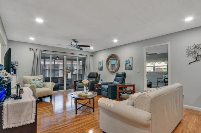 living room featuring ceiling fan and light wood-type flooring