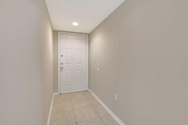 doorway to outside with light tile patterned flooring