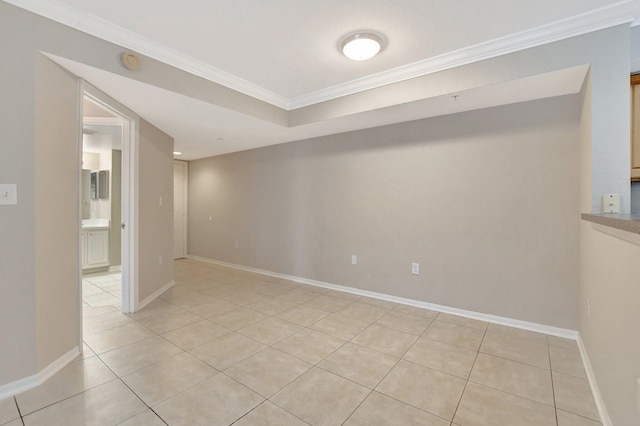 spare room featuring light tile patterned flooring and ornamental molding