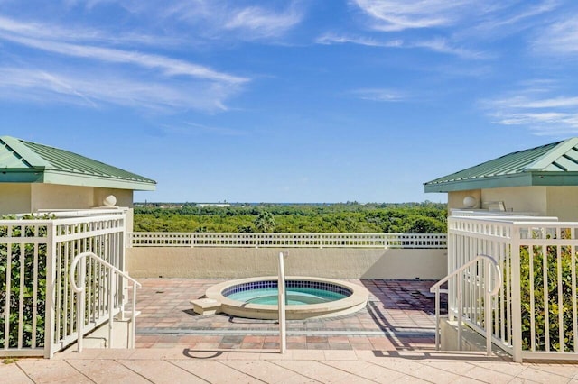 view of swimming pool featuring an in ground hot tub and a patio