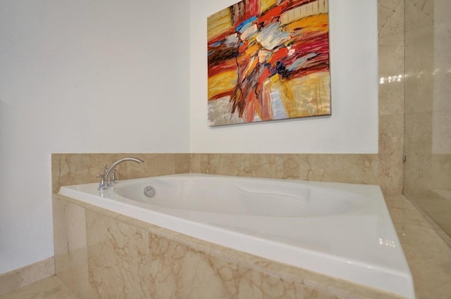 bathroom with a relaxing tiled tub