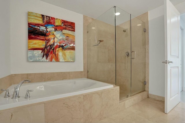 bathroom featuring shower with separate bathtub and tile patterned flooring