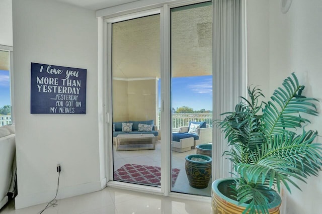 doorway to outside featuring a wall of windows and tile patterned floors