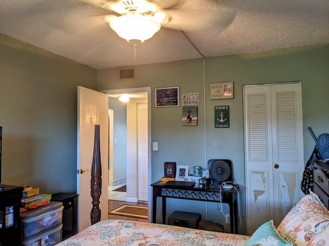 bedroom with a textured ceiling and visible vents