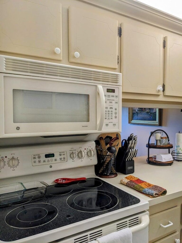 interior details featuring white appliances and light countertops