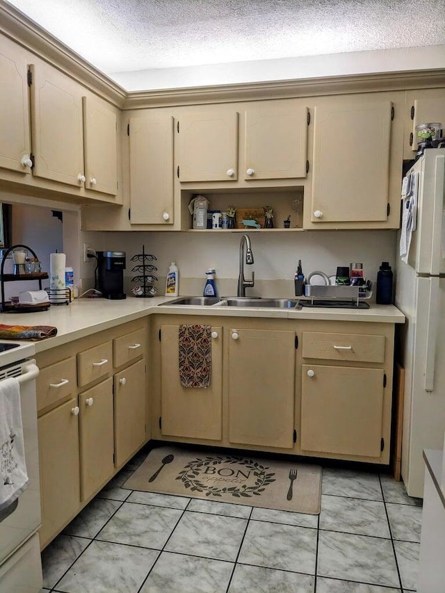 kitchen with white appliances, light countertops, a textured ceiling, open shelves, and a sink