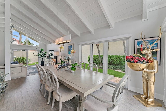 dining room with high vaulted ceiling and beam ceiling