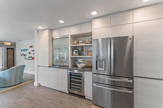 kitchen with wine cooler, light hardwood / wood-style flooring, and stainless steel refrigerator with ice dispenser