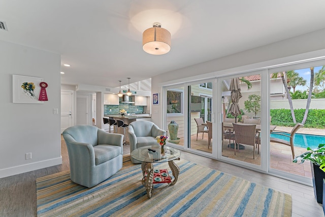 living room with plenty of natural light and hardwood / wood-style floors