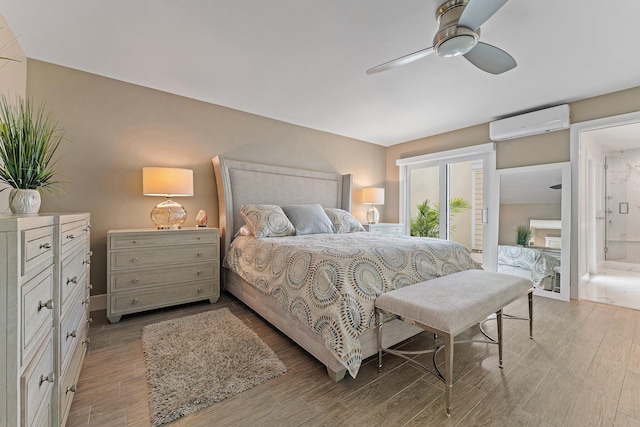 bedroom with connected bathroom, access to outside, an AC wall unit, and ceiling fan