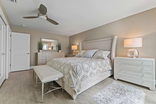 bedroom with hardwood / wood-style floors and ceiling fan