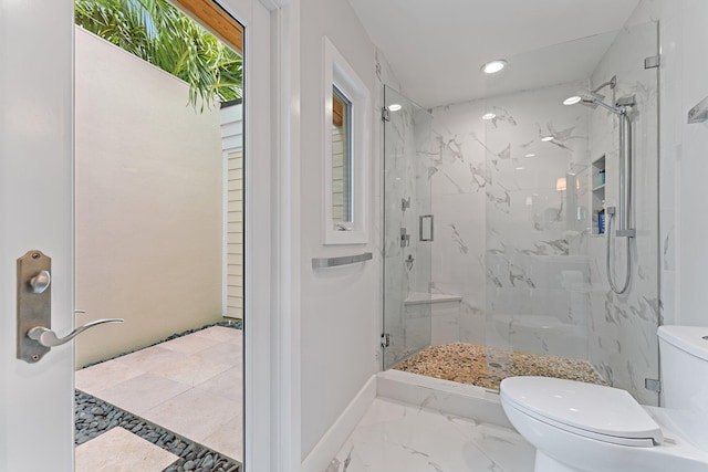 bathroom featuring toilet and walk in shower