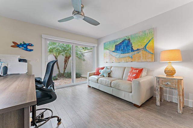 home office with ceiling fan and light hardwood / wood-style flooring