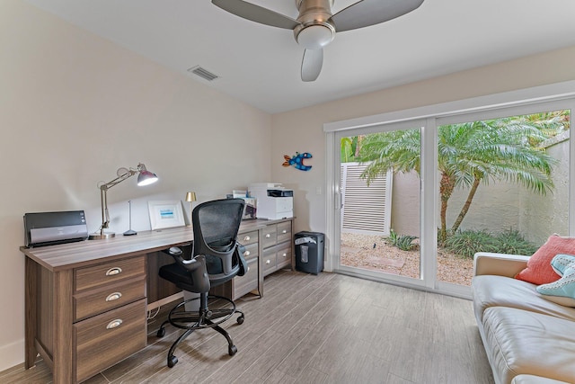 home office with ceiling fan and light wood-type flooring