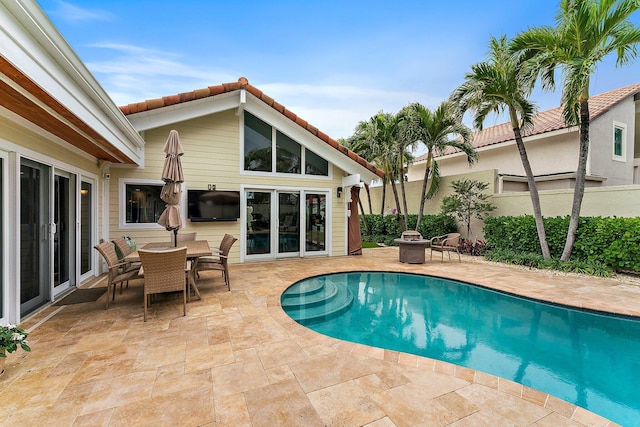 view of pool featuring a fire pit and a patio