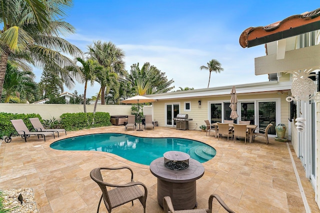 view of pool with a patio area, grilling area, and french doors